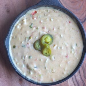 White queso dip in a cast iron skillet.
