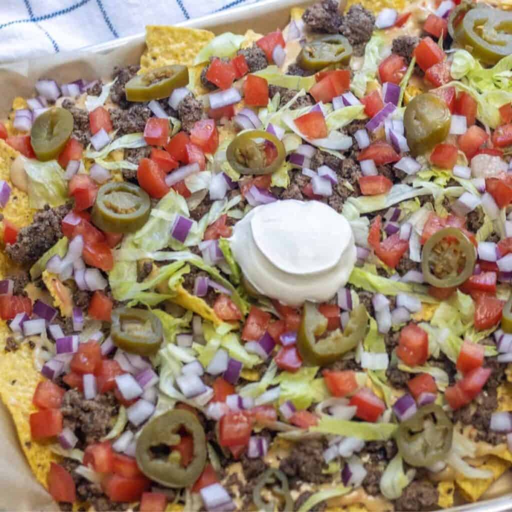 Beef nachos with a dollop of sour cream