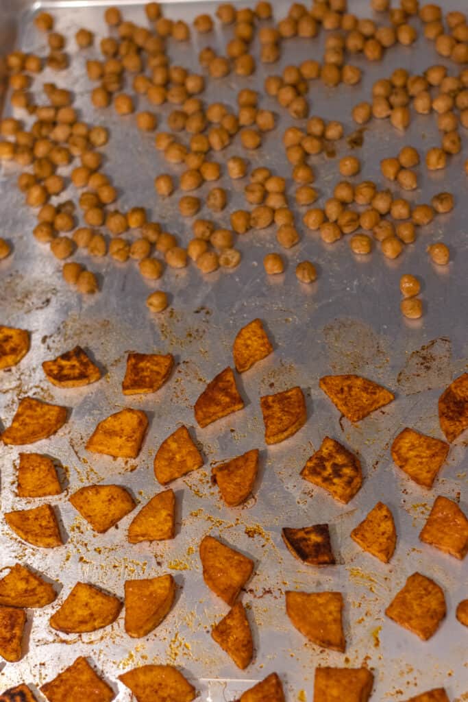 Sweet potatoes and chickpeas on a baking sheet after being roasted.