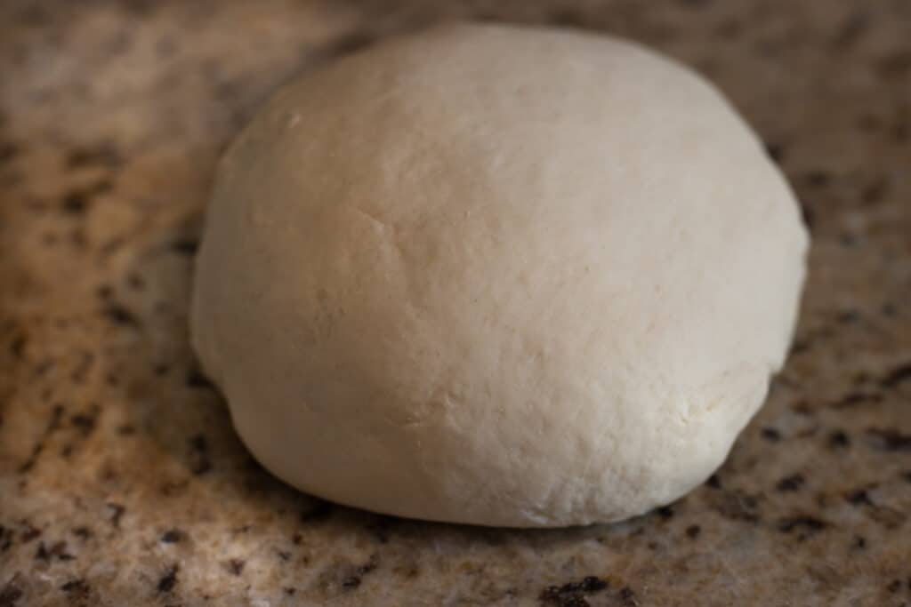 Raw kneaded ball of flatbread dough