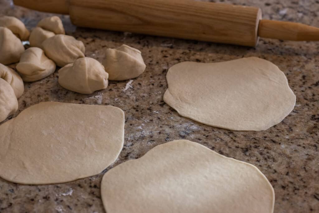 Raw flatbread dough rolled out ready to be cooked