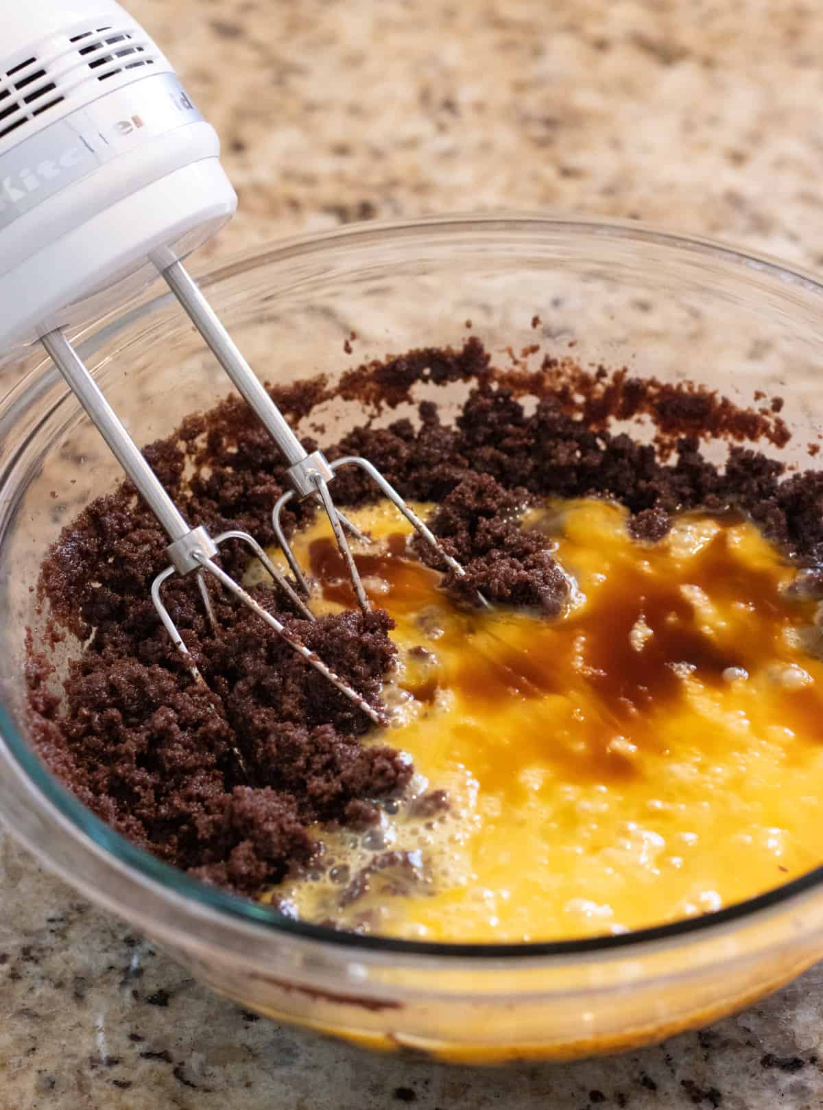 Eggs and vanilla added to brownie batter.