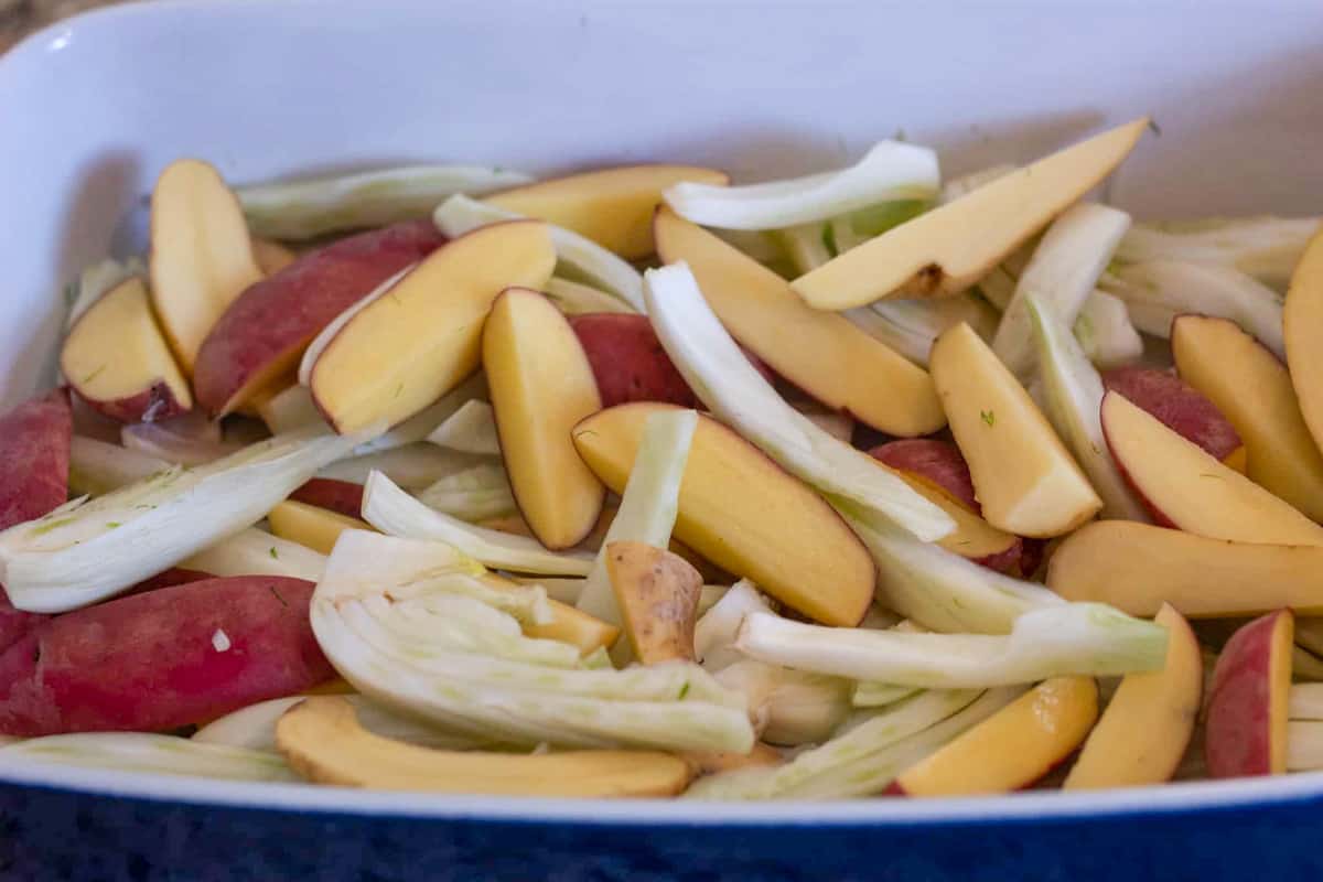 Potato and fennel wedges in a baking dish.