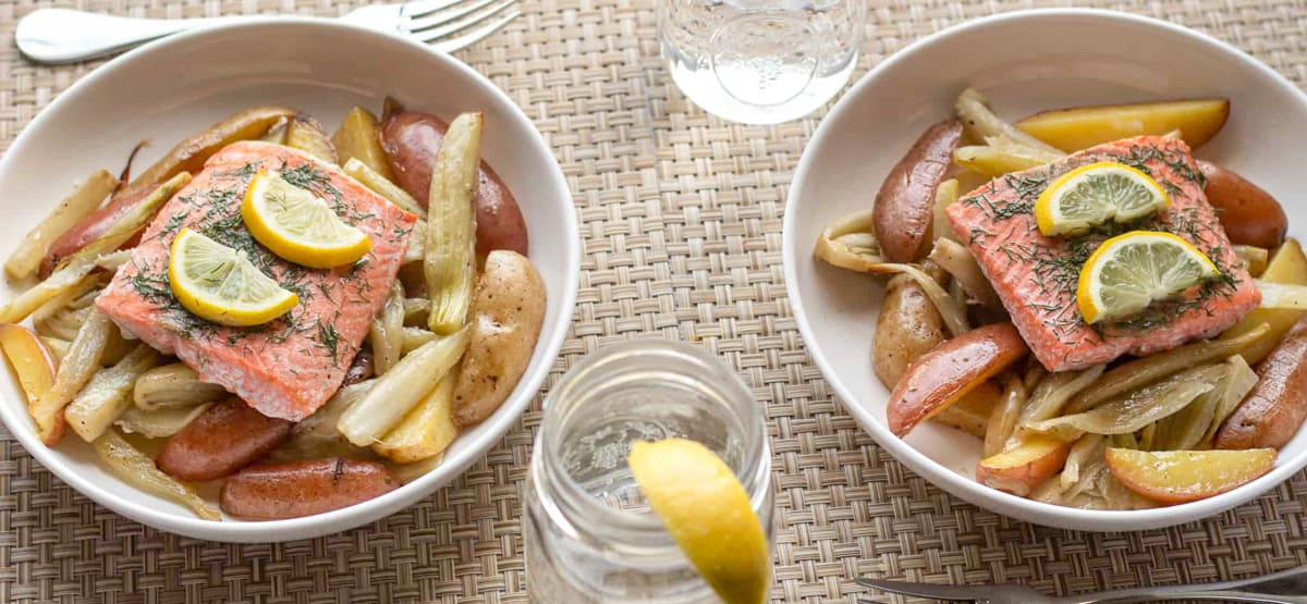 Salmon with lemon slices and dill over potatoes and fennel.