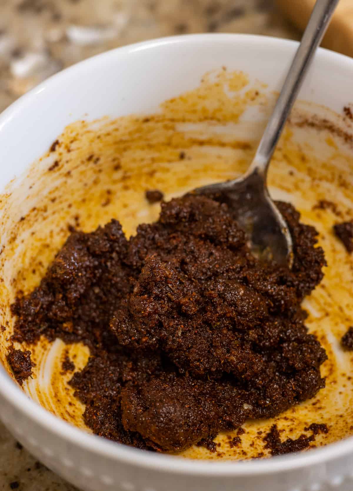 Adobo spice paste in a bowl with a spoon.