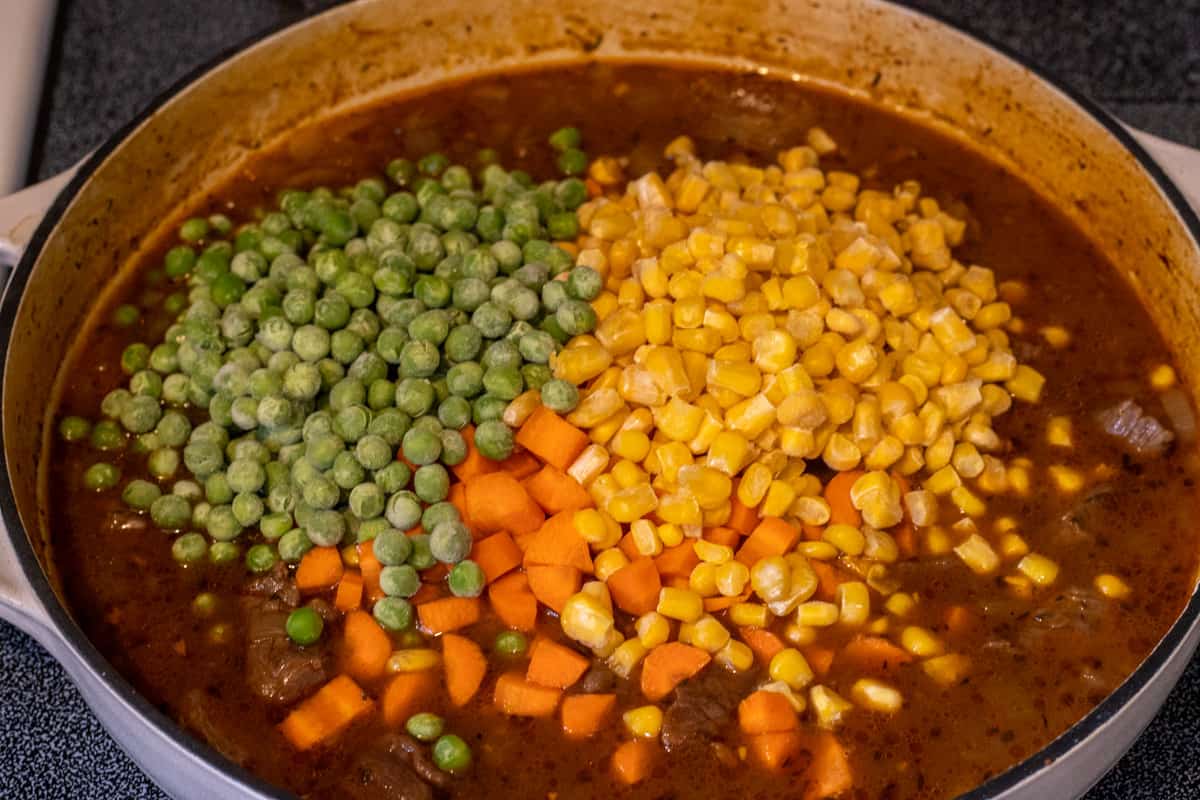 Carrots, corn, and peas added to the stew meat and broth for shepherd's pie.