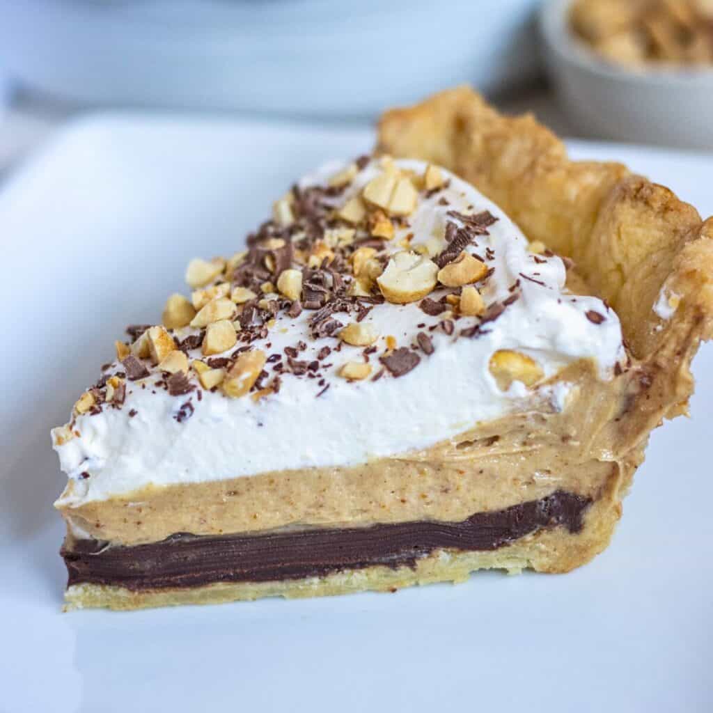 Slice of chocolate peanut butter pie on a plate.