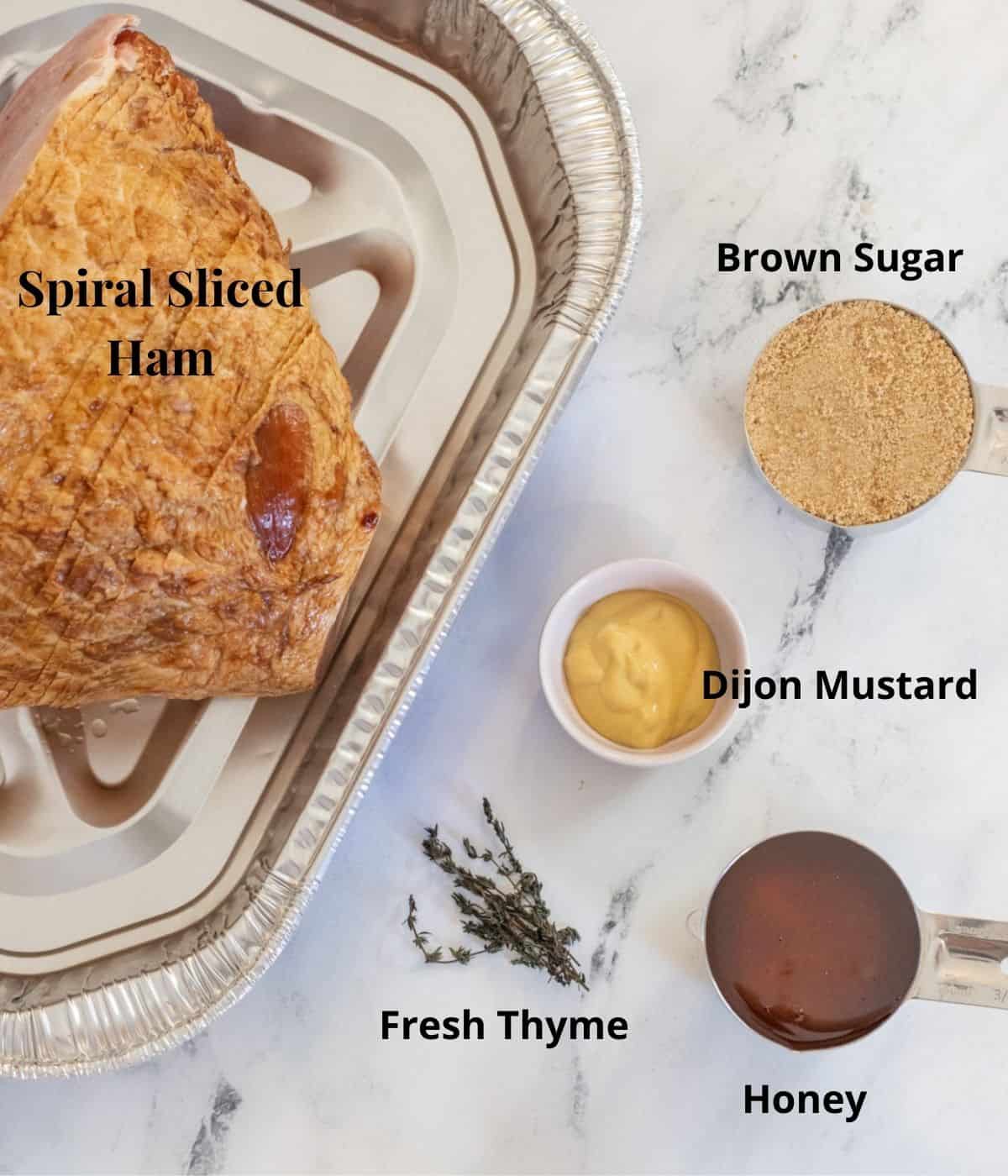 Ingredients for honey glazed ham on a counter with labels over each one.