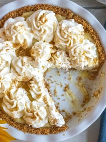 Overhead shot of pineapple cream pie with a slice cut out.