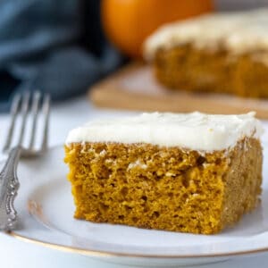 Slice on pumpkin cake on a plate with a fork.