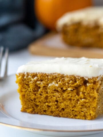 Slice on pumpkin cake on a plate with a fork.