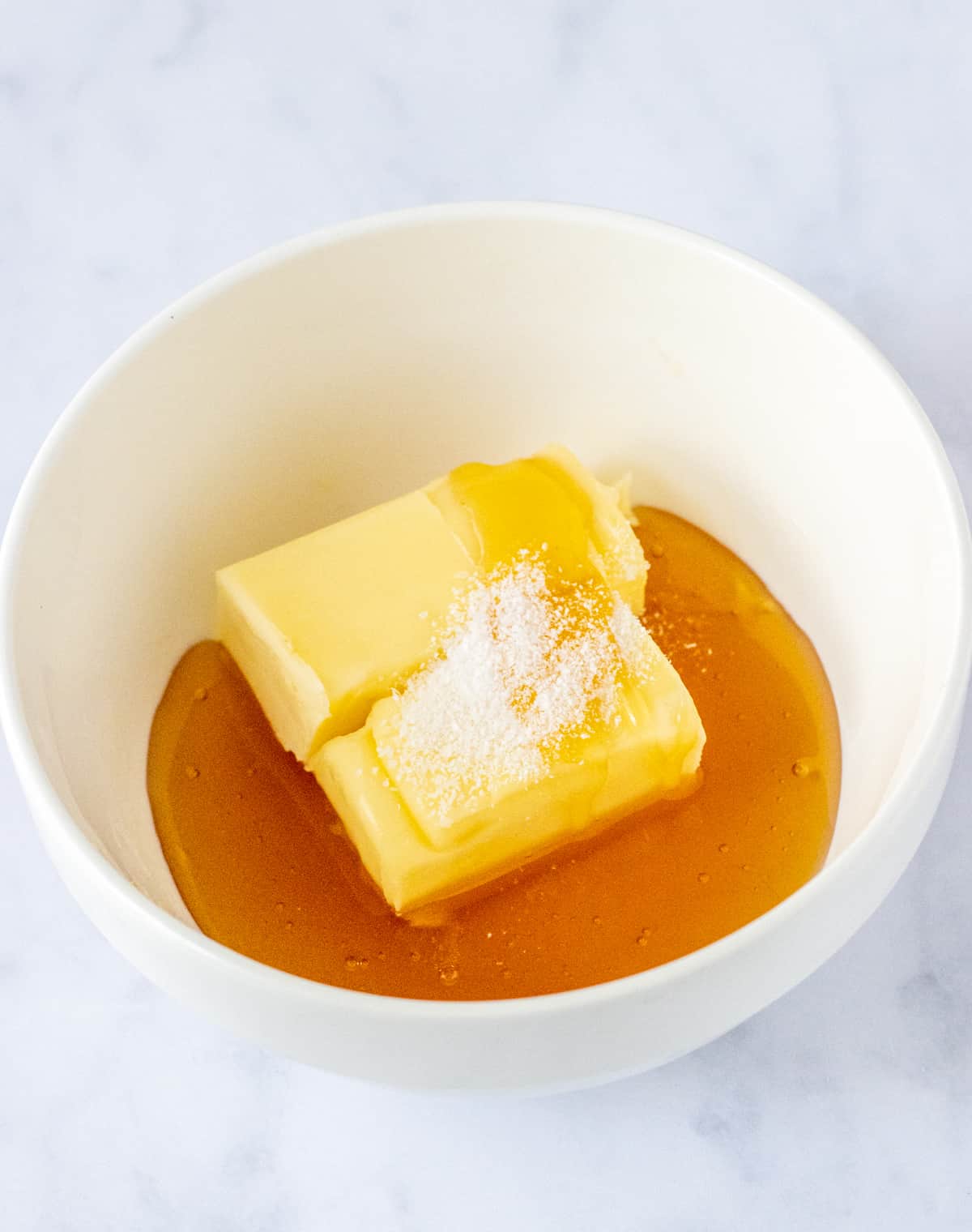 Butter, honey, and salt in a bowl.