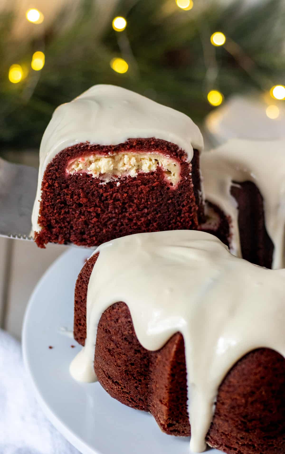 Slice of red velvet bundt cake pulled out of the rest of the cake.