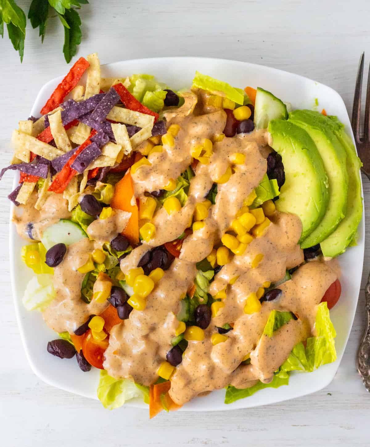 Tex mex salad drizzled with bbq ranch dressing.