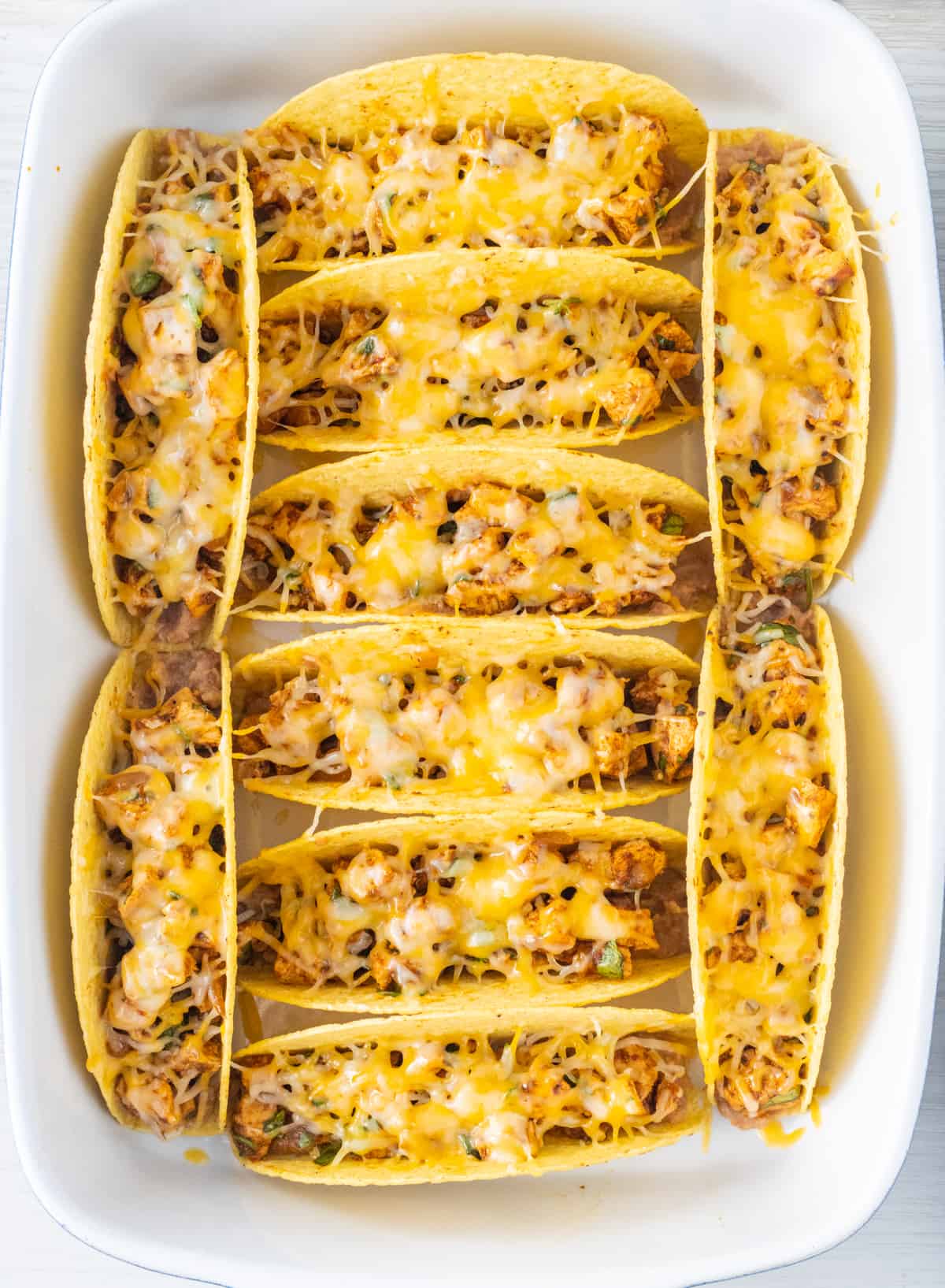 Baked chicken tacos in the baking dish.