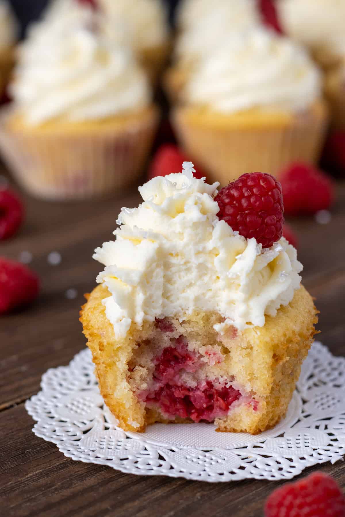 Raspberry cupcake with a bite out of it.