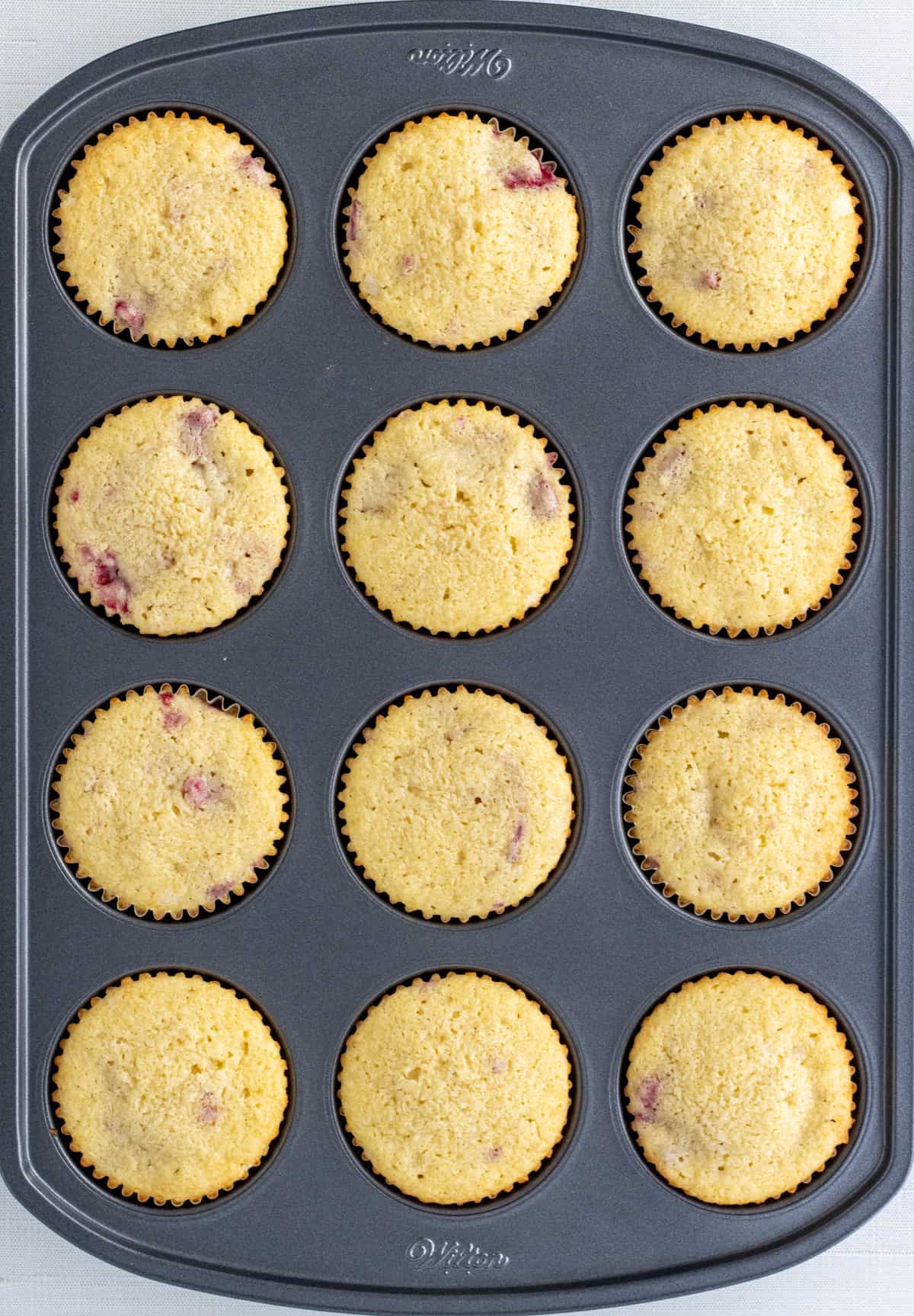 Baked raspberry cupcakes in the cupcake pan.
