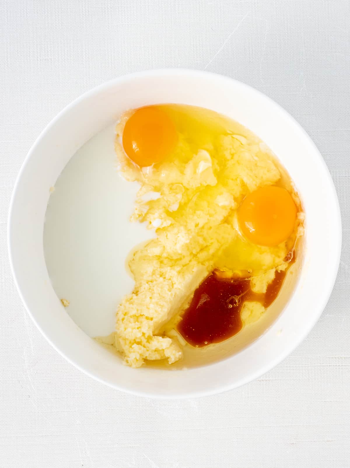 Oil, milk, two eggs, and vanilla extract added to creamed butter and sugar.