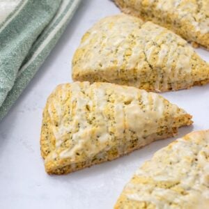 Lemon poppy seed scones next to a green and white towel.
