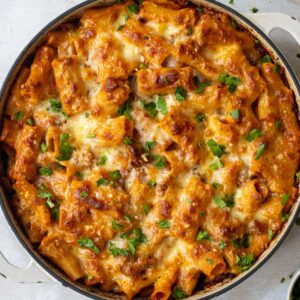 Baked rigatoni with sausage in a skillet.