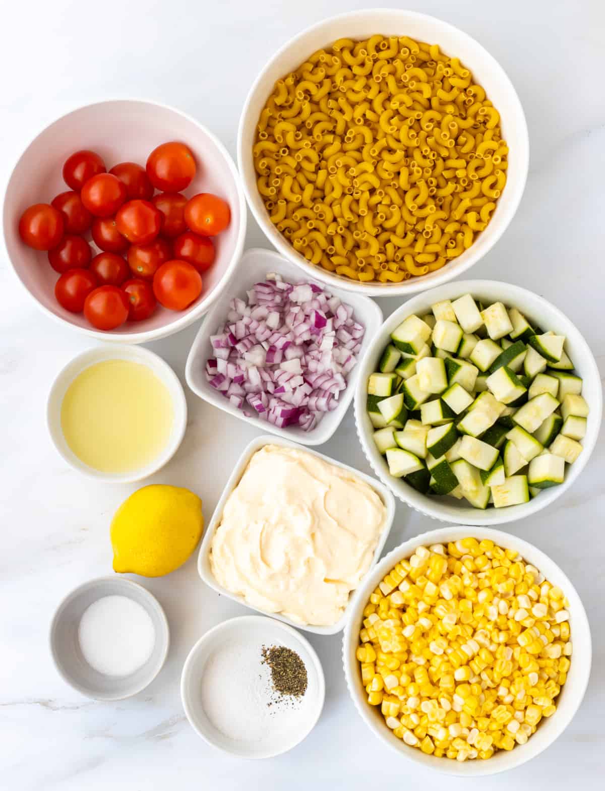 Ingredients for creamy corn and zucchini pasta salad.
