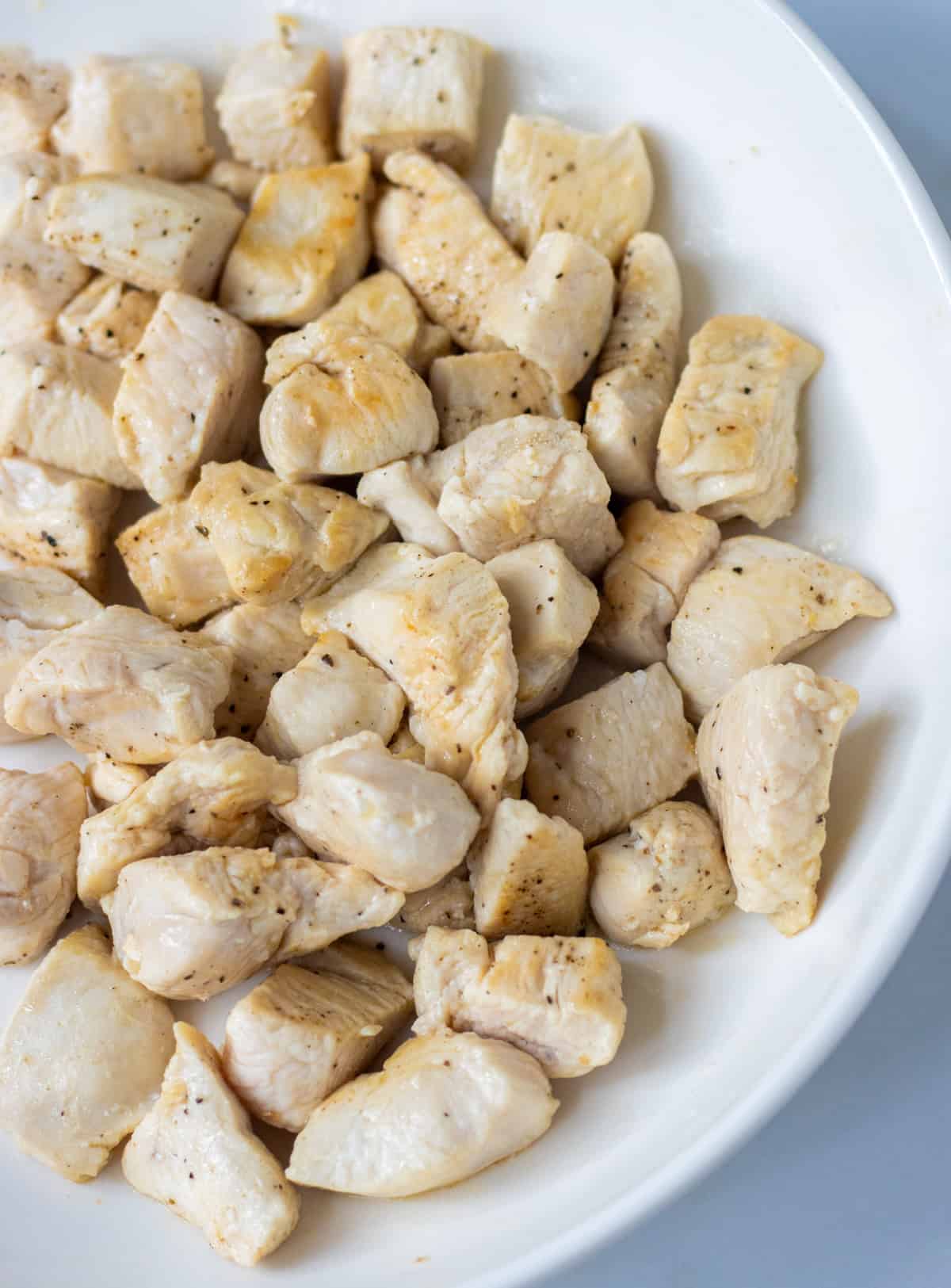 Cooked diced chicken on a plate.