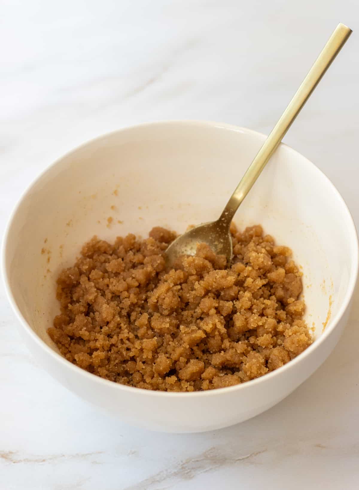 Streusel in a bowl with a spoon.