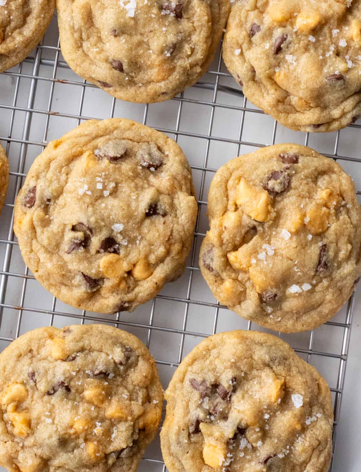 Salted butterscotch chocolate chip cookies on a wire rack.