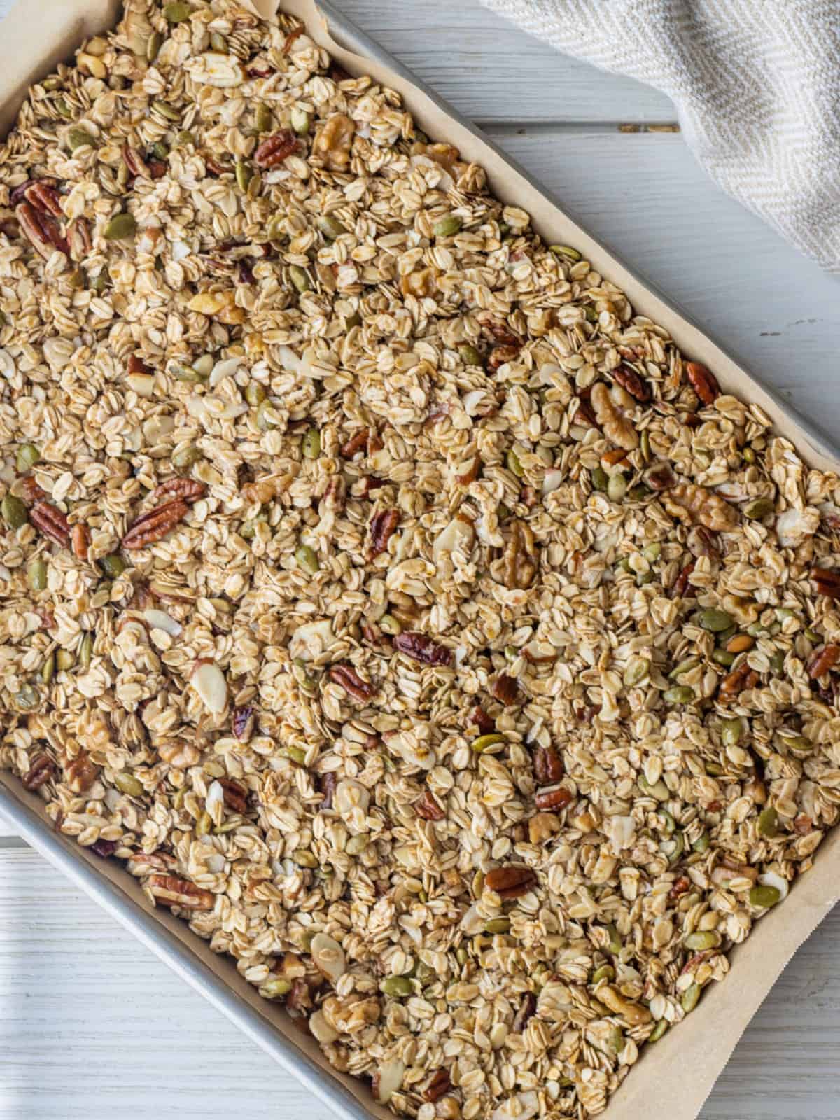 Granola on a parchment-lined baking sheet.