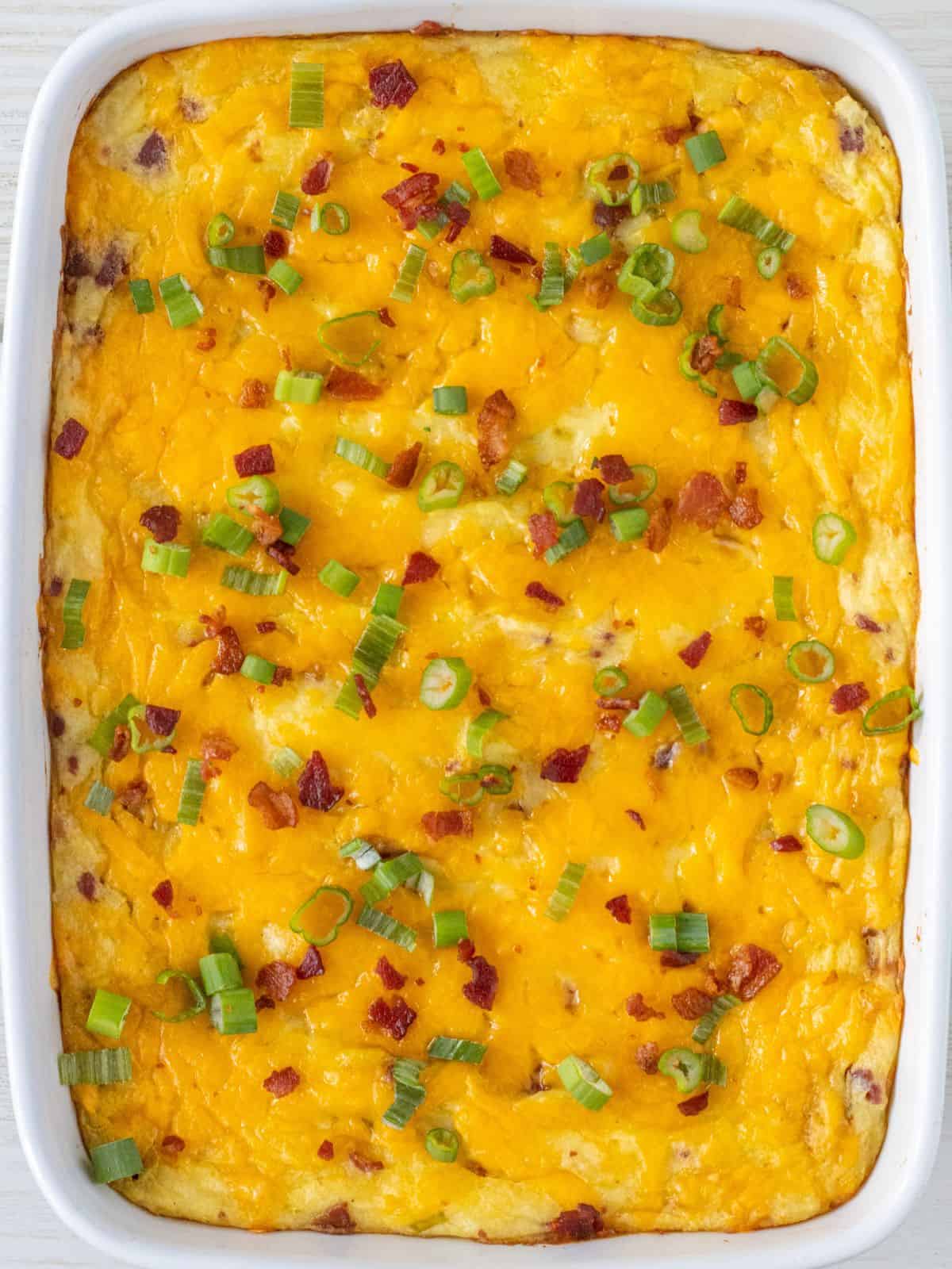 Baked loaded mashed potatoes in a baking dish.