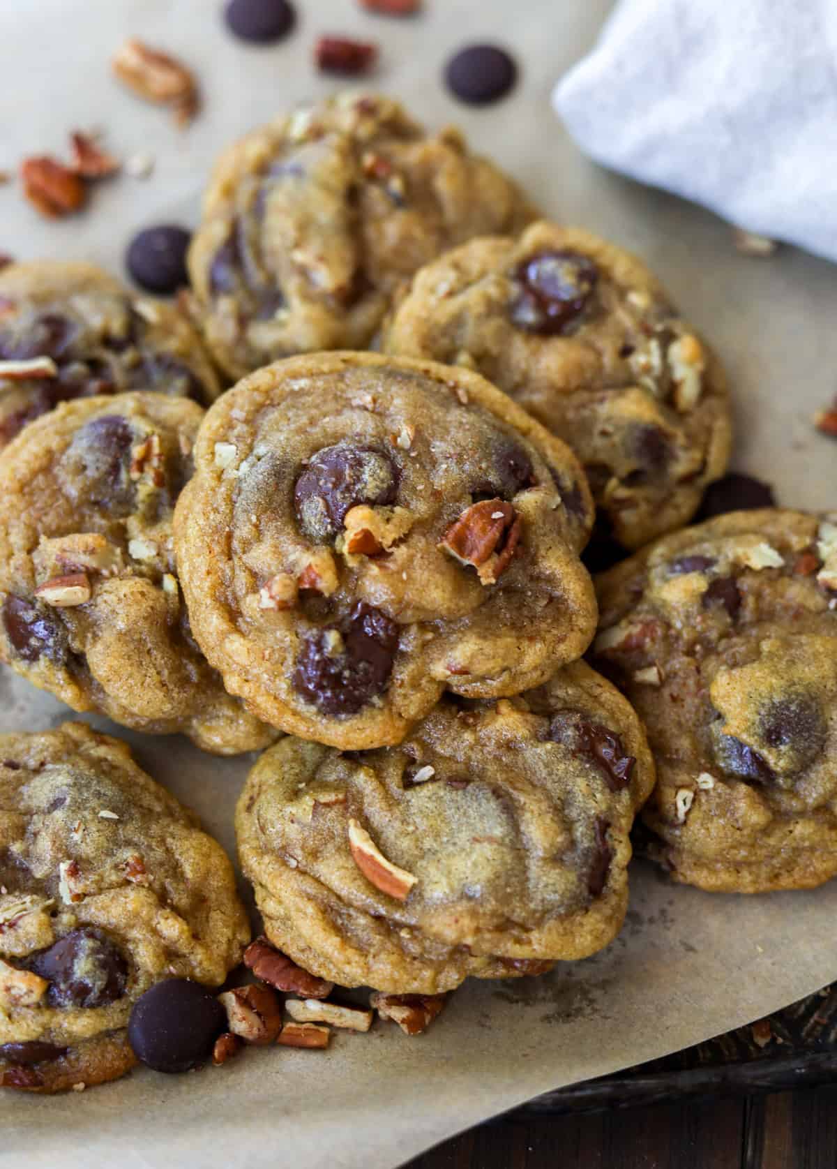 Chocolate chunk pecan cookies in a pile.