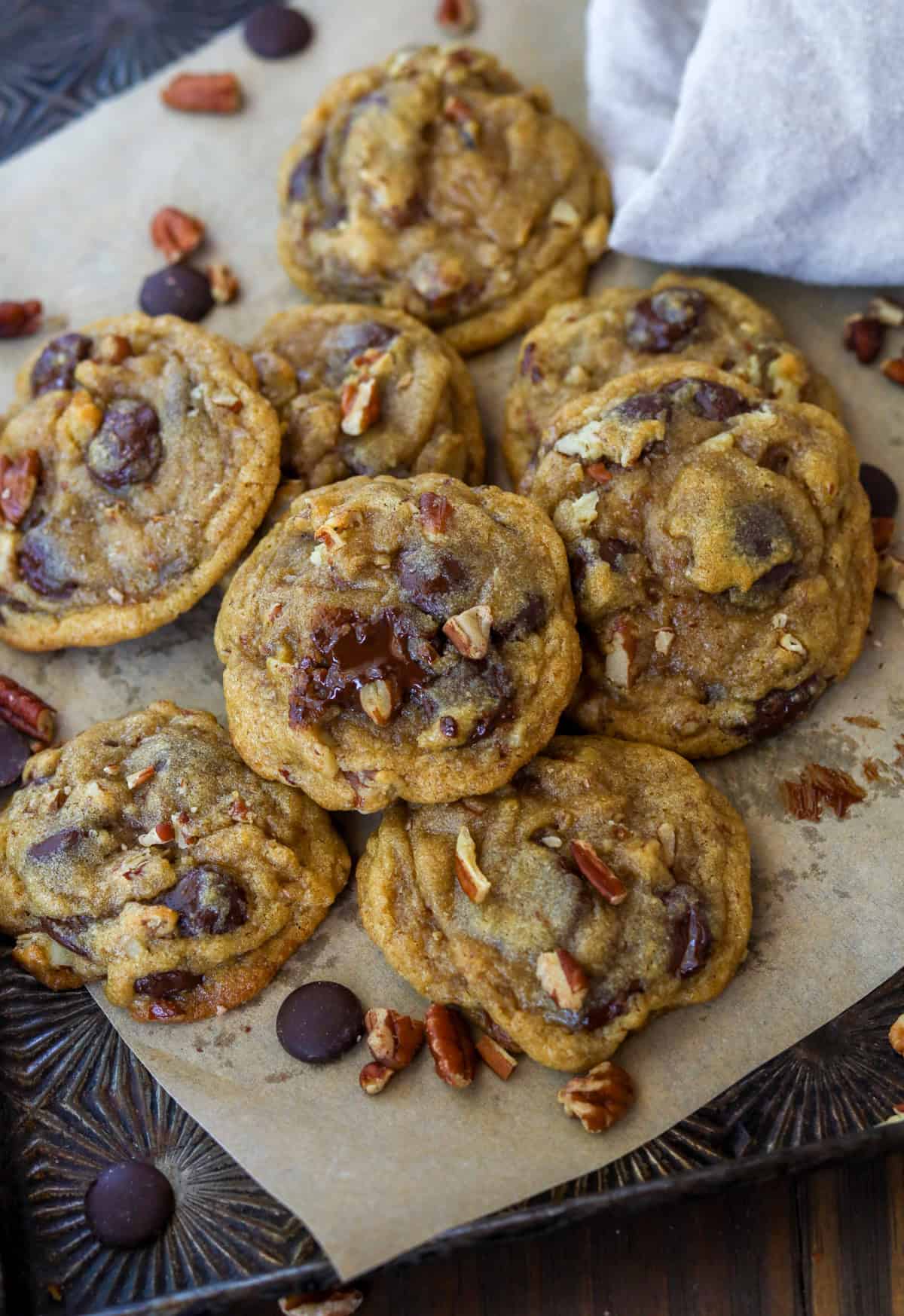 Chocolate chunk pecan cookies in a pile.